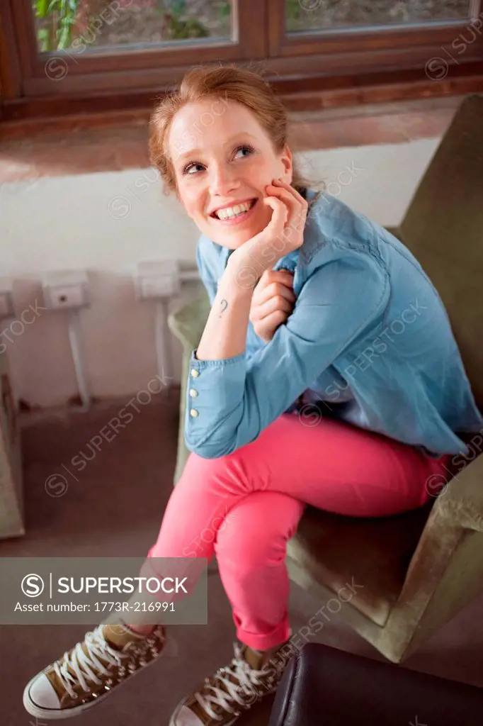 Young woman sitting with legs crossed
