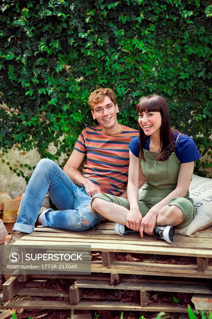 Couple sitting on wooden palettes