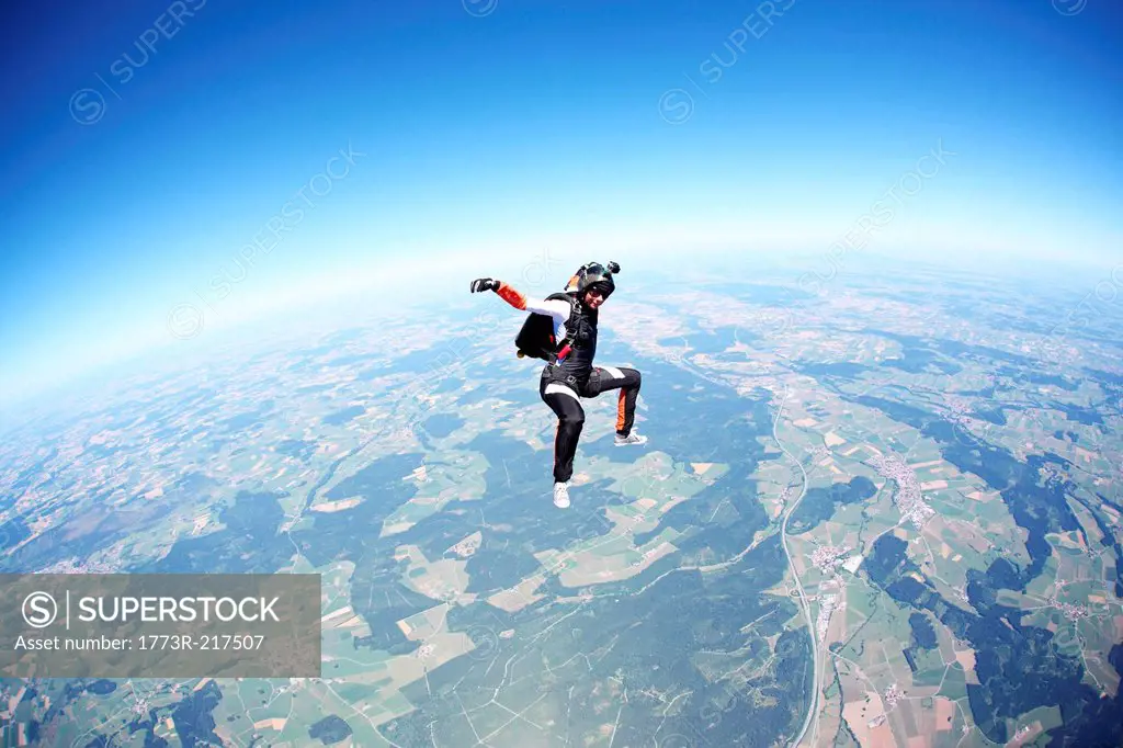 Female skydiver free falling above Leutkirch, Bavaria, Germany