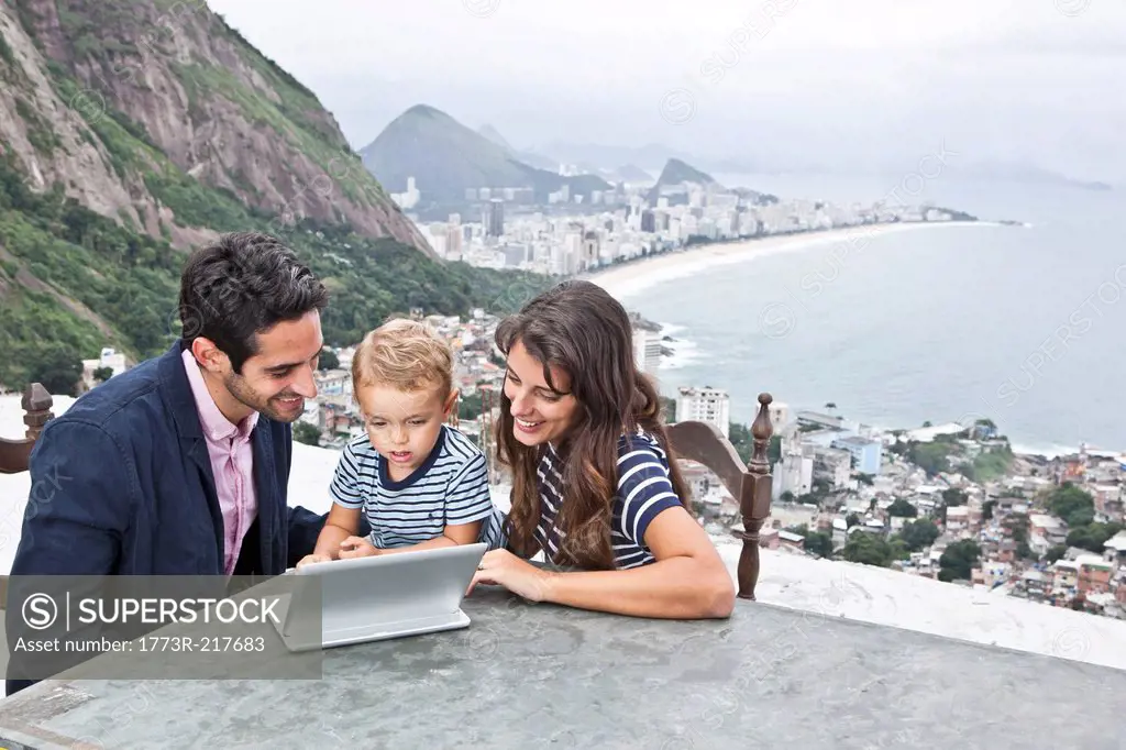 Young family using laptop, Casa Alto Vidigal, Rio De Janeiro, Brazil