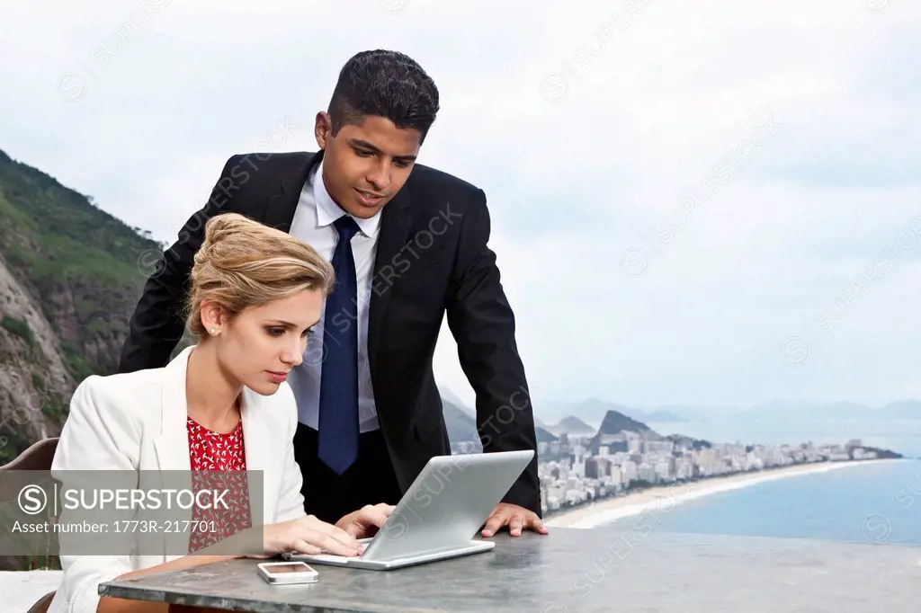 Young couple using laptop, Casa Alto Vidigal, Rio De Janeiro, Brazil