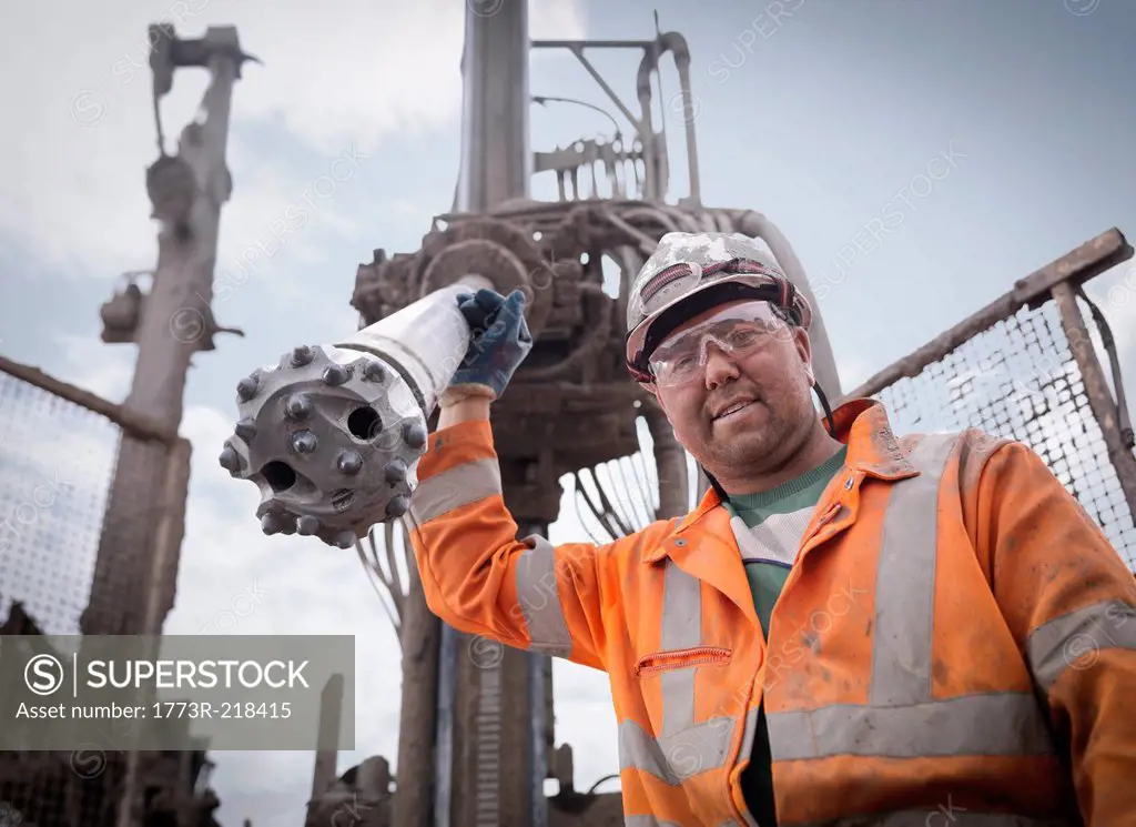 Portrait of drilling rig worker in hard hat and workwear