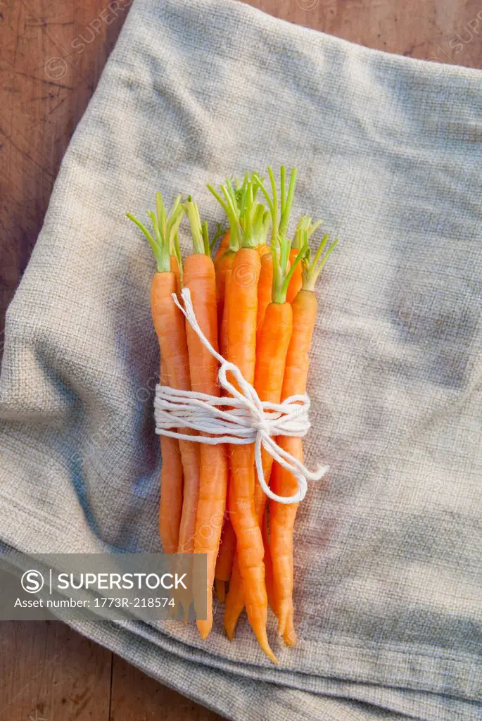 Bunch of carrots tied with string, still life