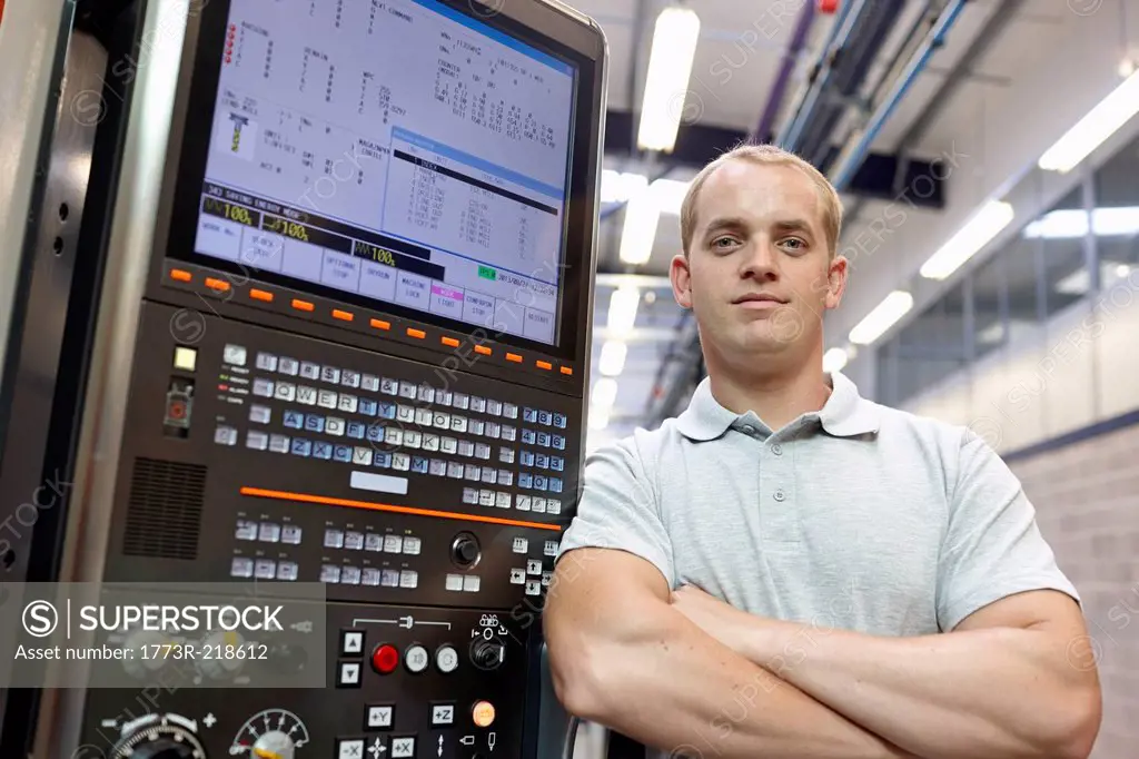 Portrait of engineer and control panel in engineering factory