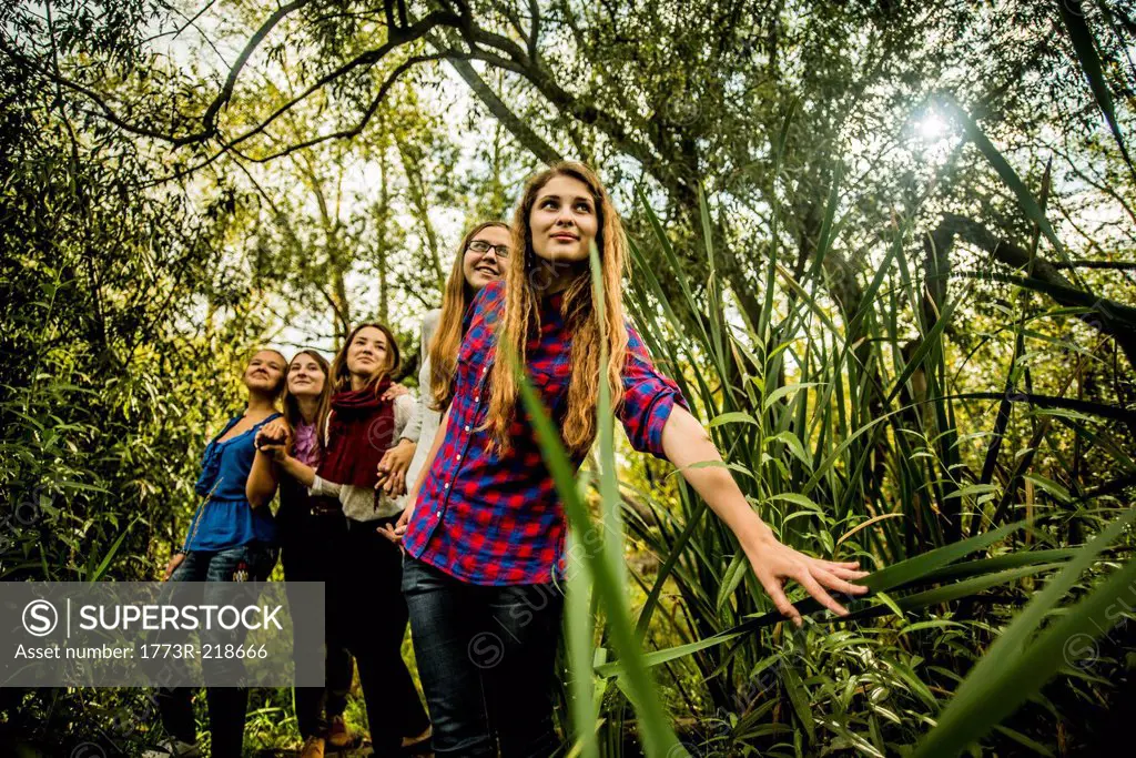 Five young women exploring marshland