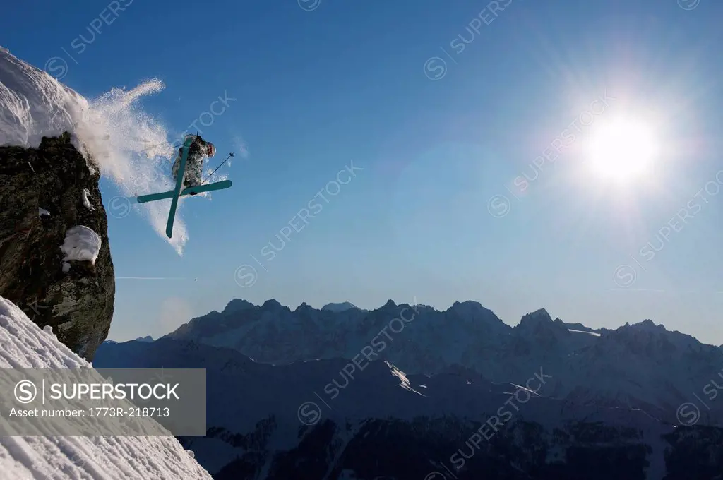 Man skiing off cliff, Verbier, Switzerland