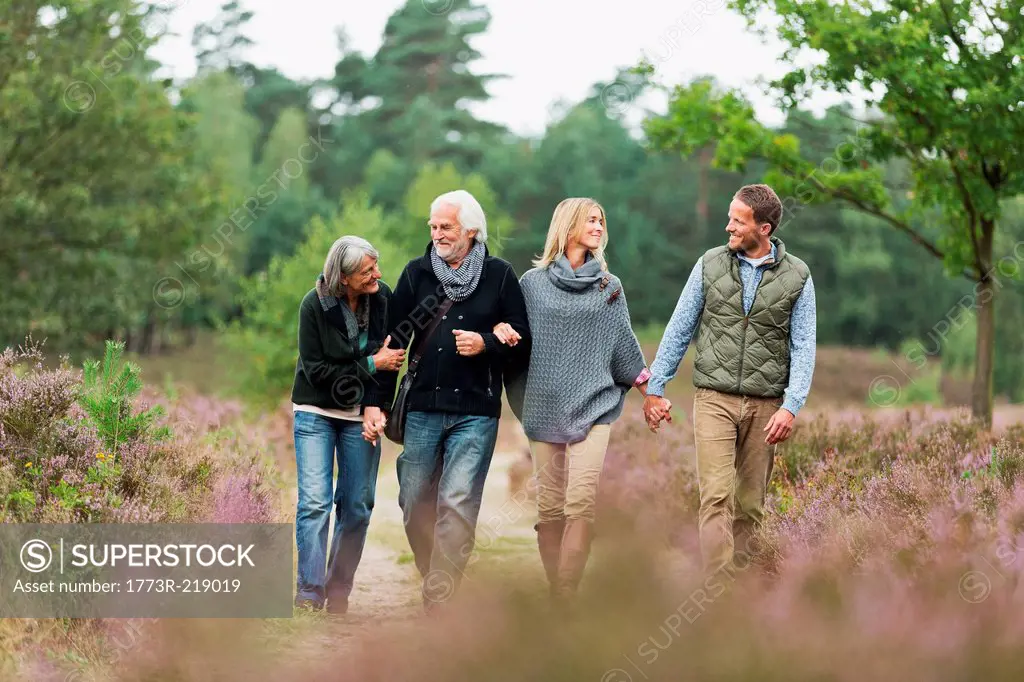 Two couples walking through forest