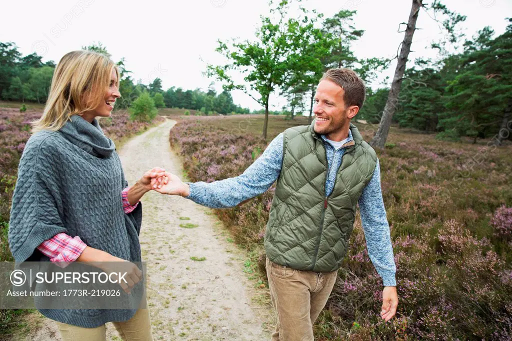 Mid adult couple holding hands on path