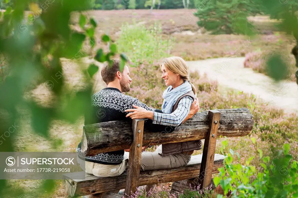 Mid adult couple on wooden bench