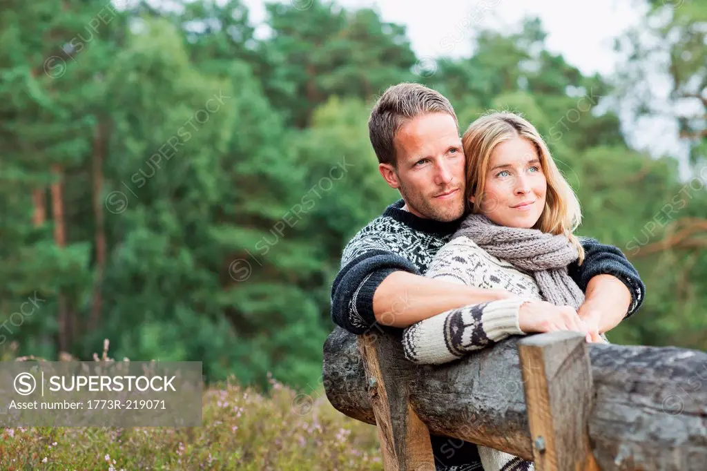 Mid adult couple on bench looking away
