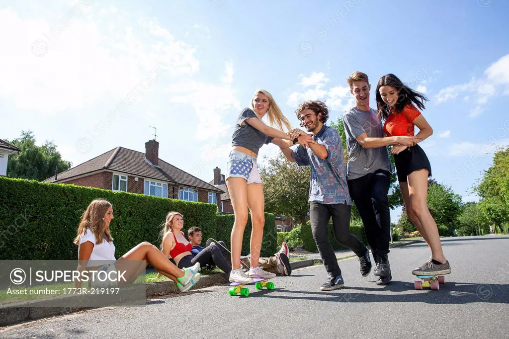 Group of young adults having fun on skateboards