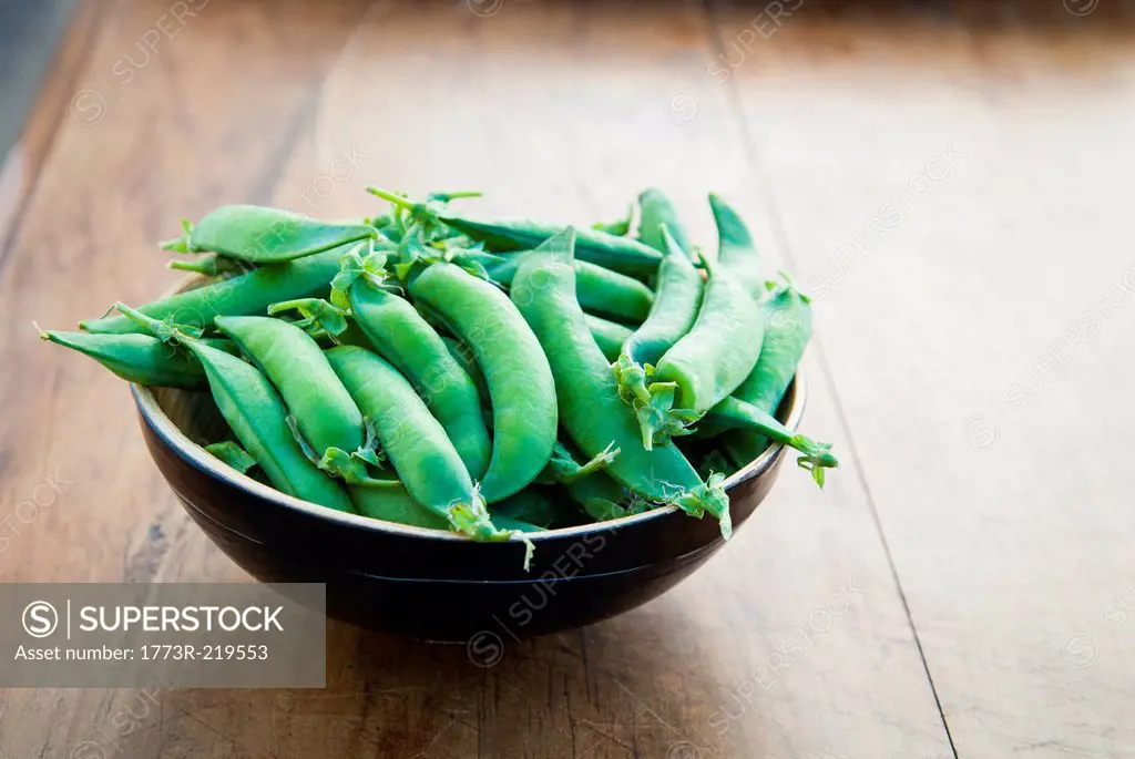Bowl of peapods on table
