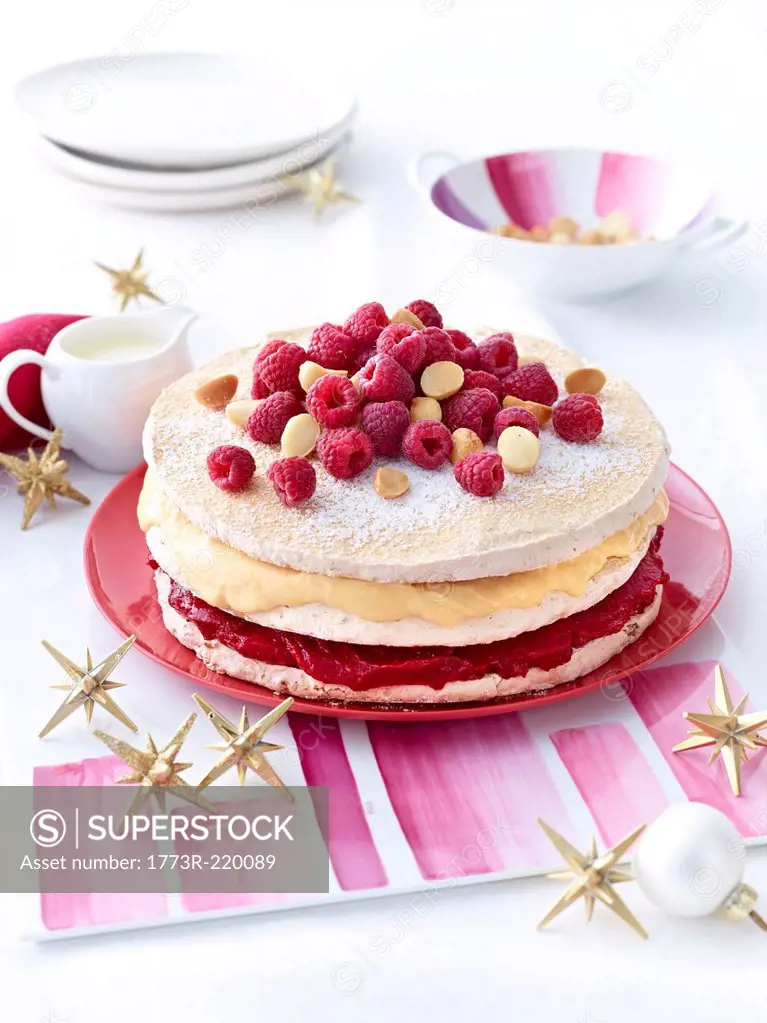 Meringue layer cake with raspberries and macadamia nuts