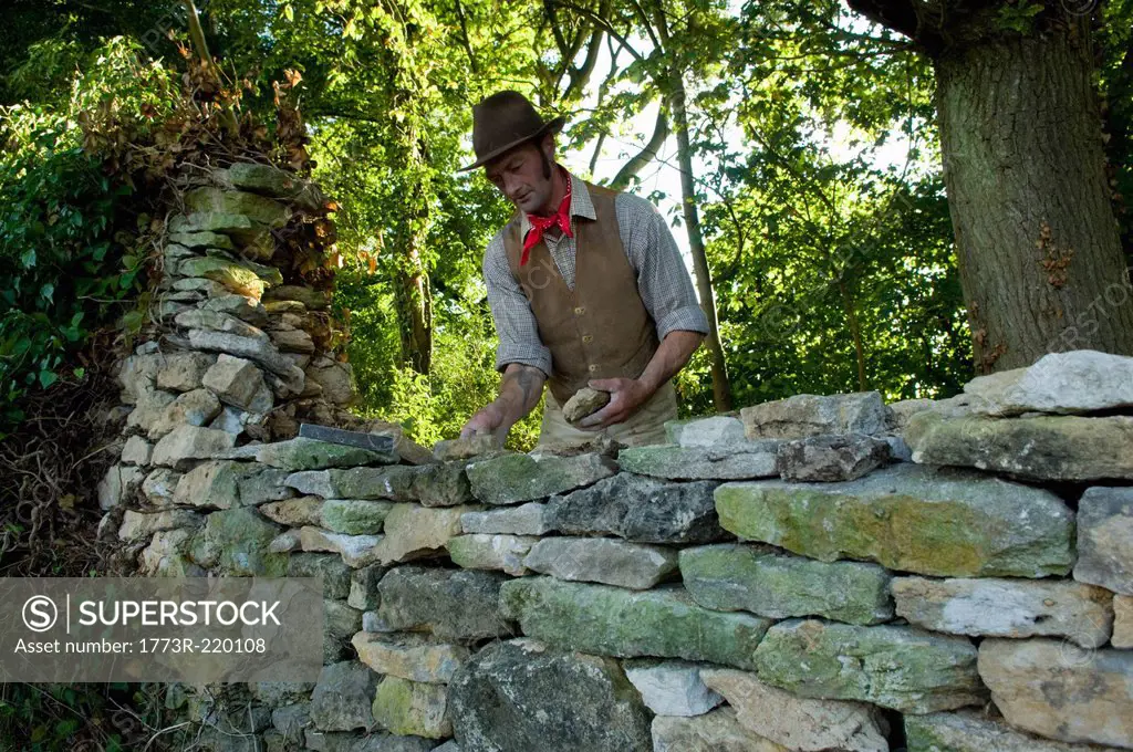 Farmer repairing dry stone wall