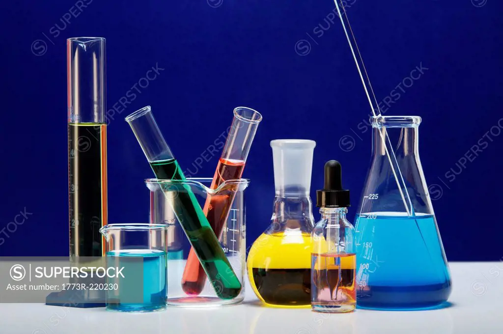 Chemical lab glassware: graduated cylinder, small beaker, beaker with two test tubes, flat-bottom flask, dropper bottle, Erlenmeyer flask with stirrin...