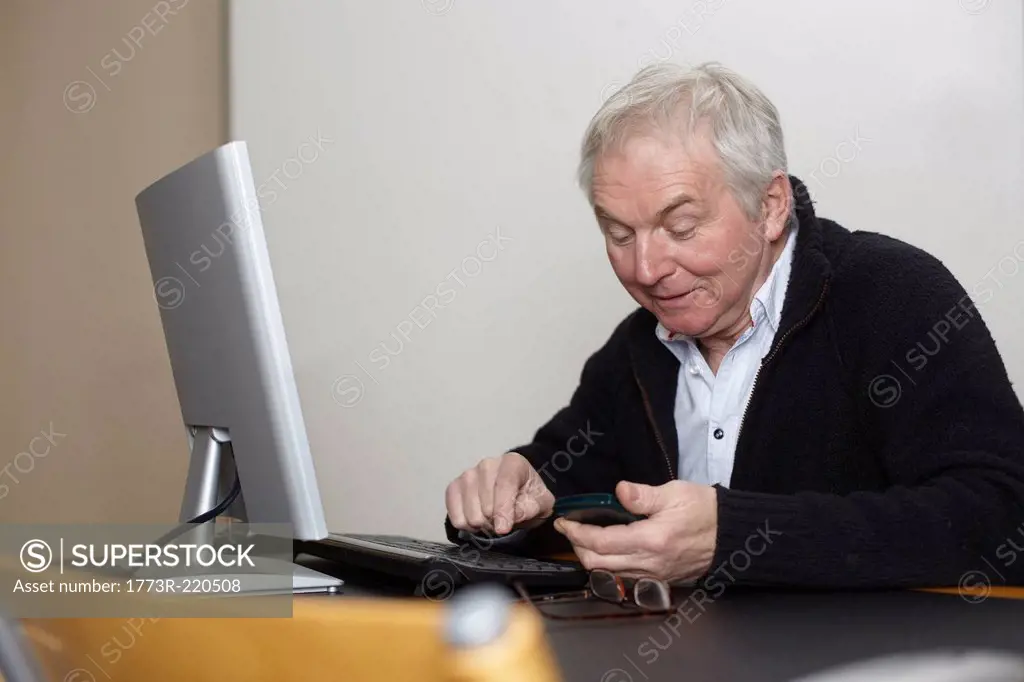 Senior man at home using personal computer