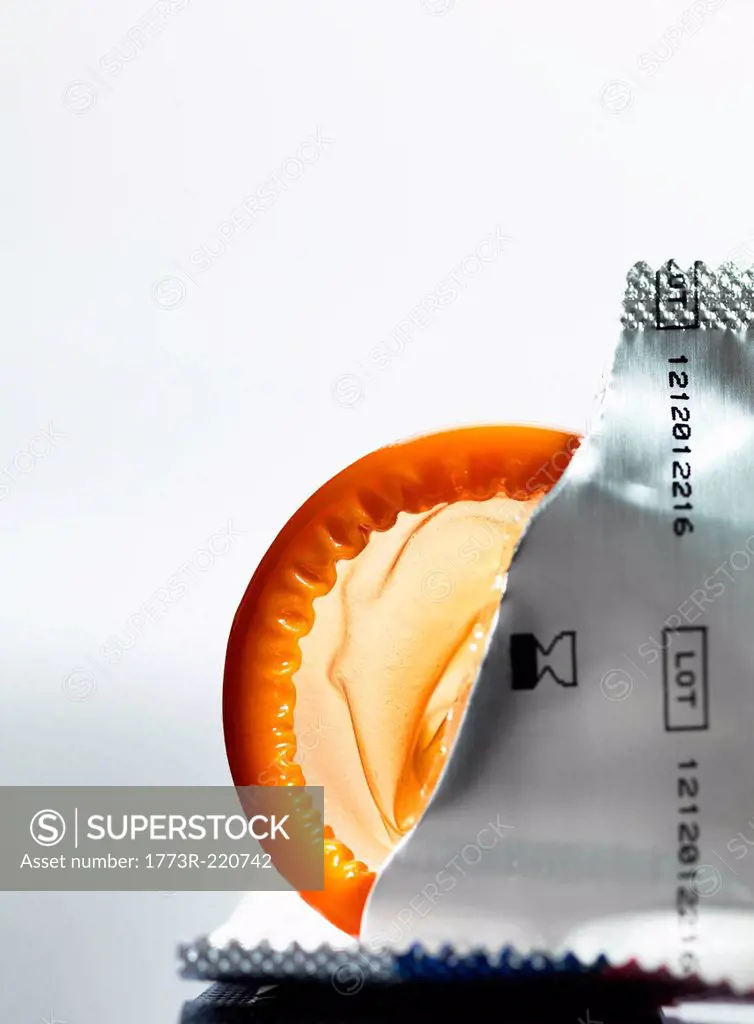 Torn packaging of wrapper containing a condom
