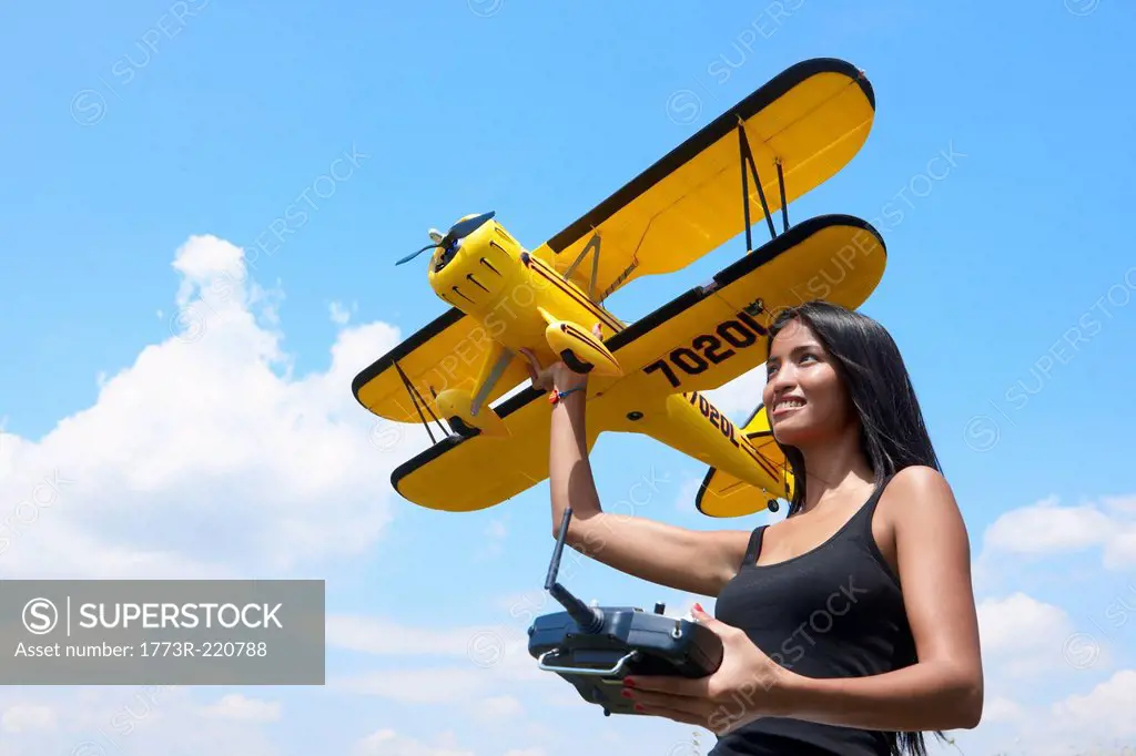 Woman preparing to launch model plane