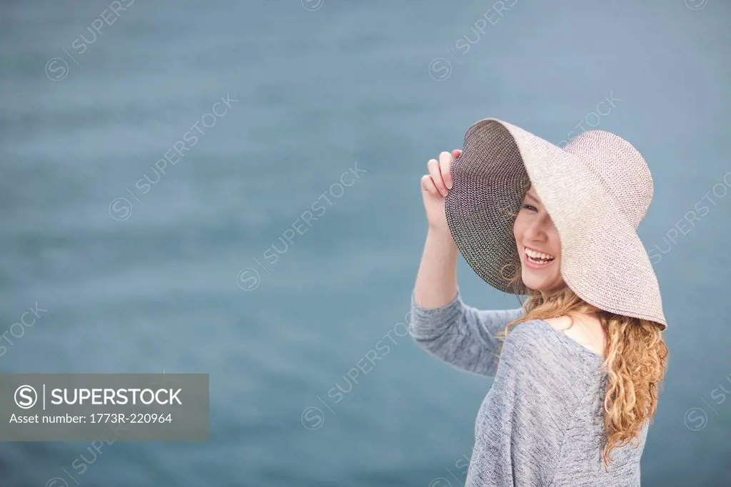Woman wearing hat enjoying sea