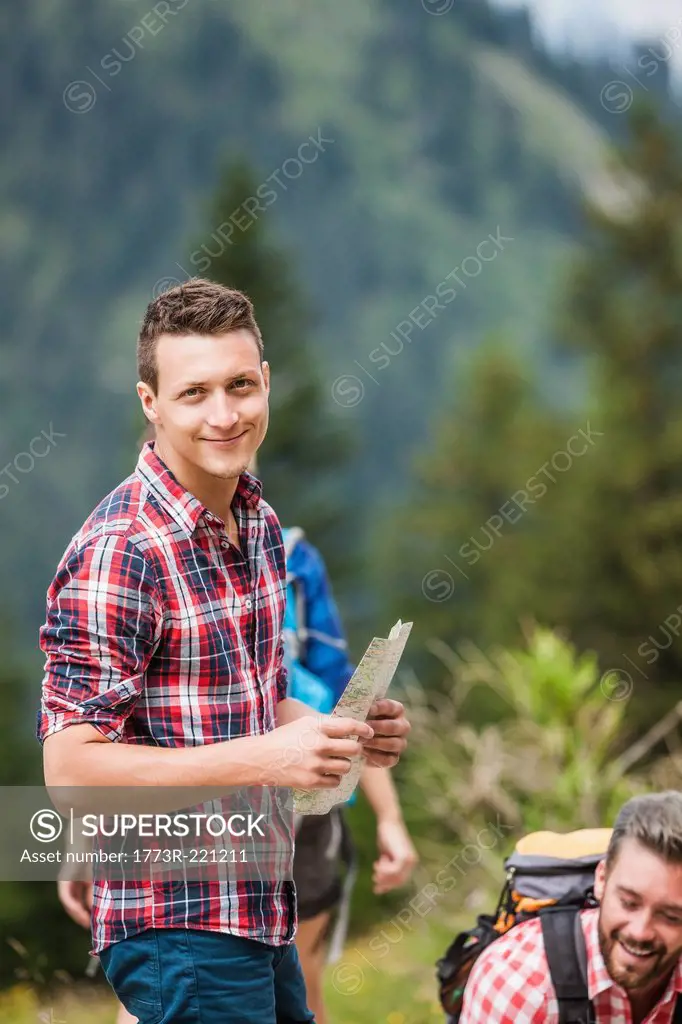 Young man with map, Tyrol, Austria