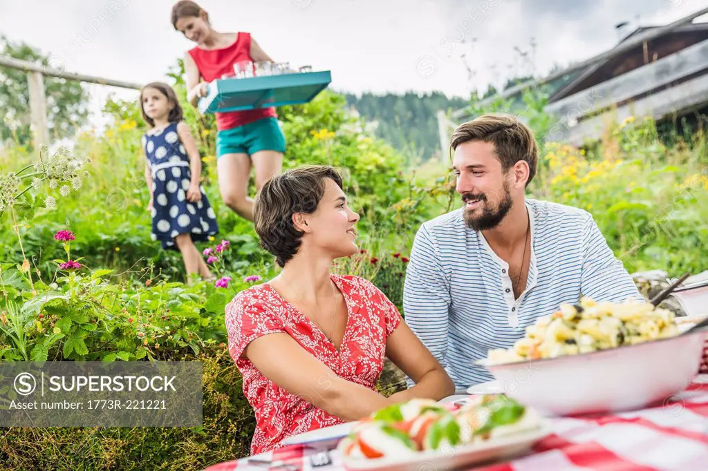 Young couple sharing picnic lunch, Tyrol, Austria