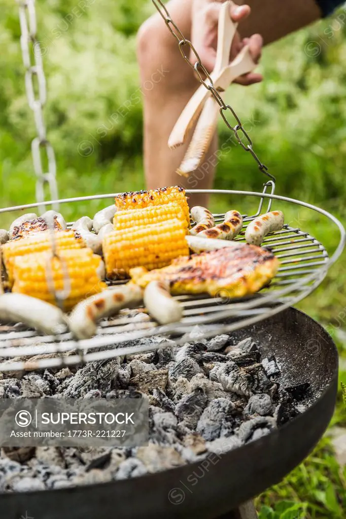 Close up of young man barbecuing lunch