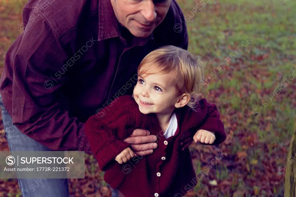 Father and daughter walking through forest