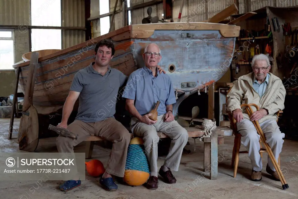 Group portrait of three generations of male boat builders
