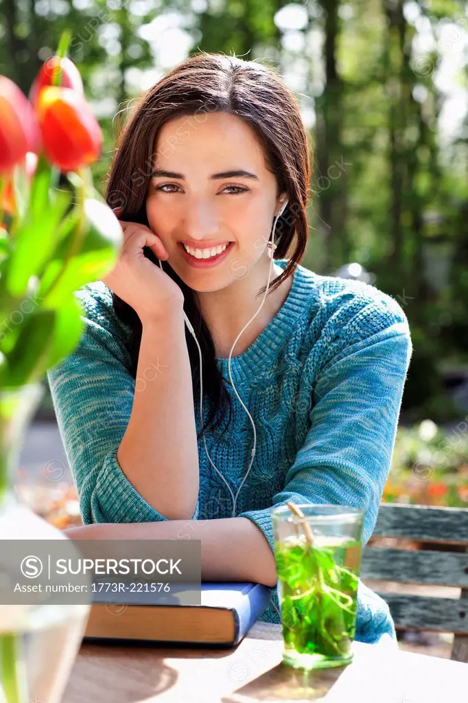 Portrait of young woman listening to earphones