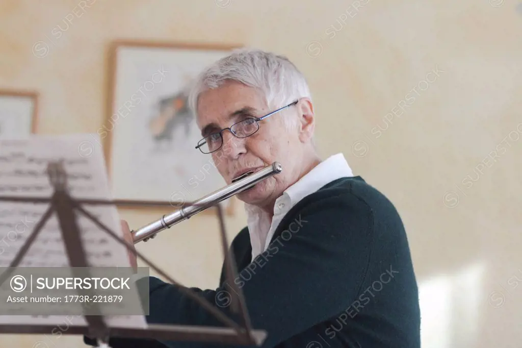 Senior woman playing flute