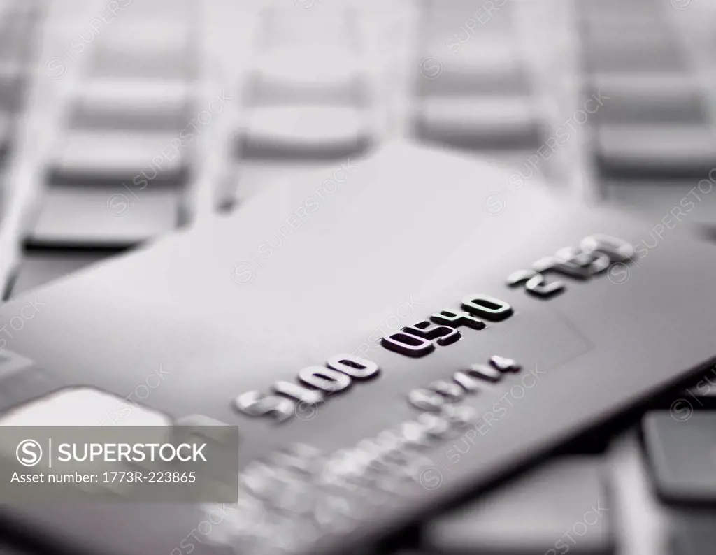 Credit card on laptop to illustrate internet shopping and internet fraud