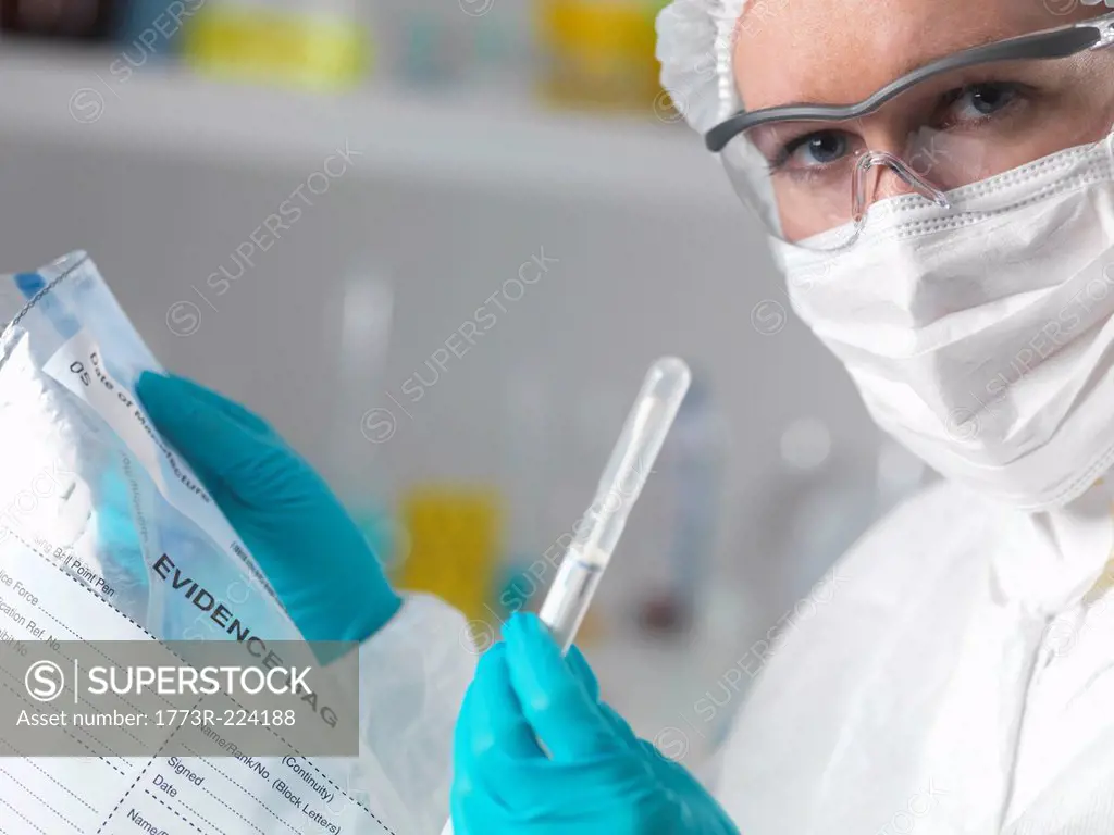 Forensic scientist in laboratory with evidence bag and swab for crime investigation