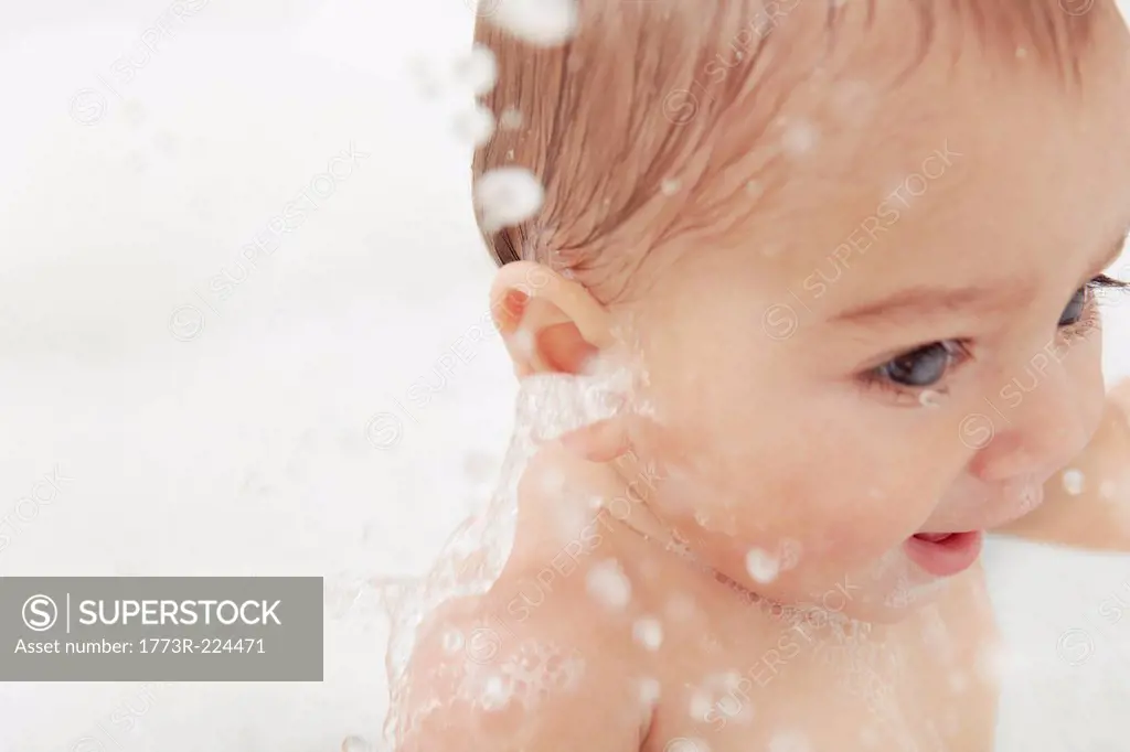 Baby splashing in bathtub