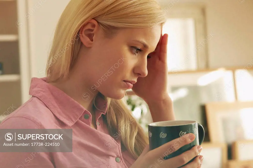 Young woman holding hot drink