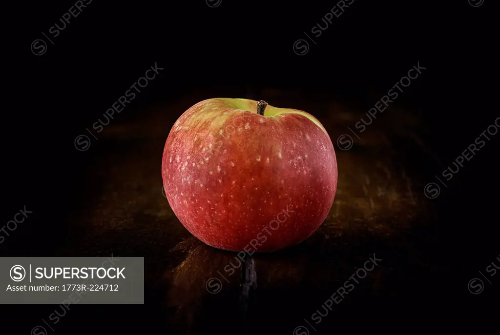 Still life of red apple on rustic wooden table