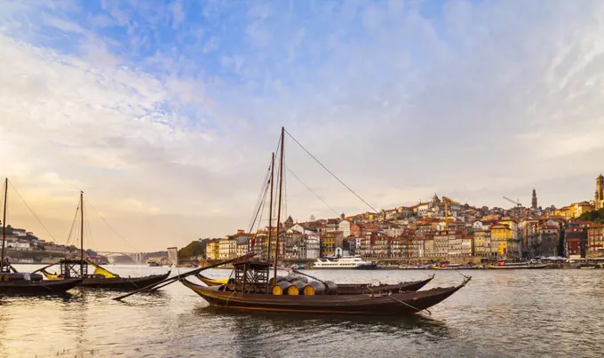 Traditional Portuguese wooden cargo boats transporting port wine on Douro River, Porto, Portugal
