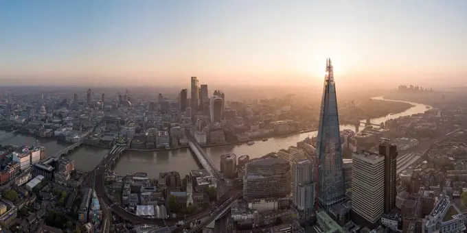 Aerial View of The Shard landmark tower and City of London, and the River Thames at dawn