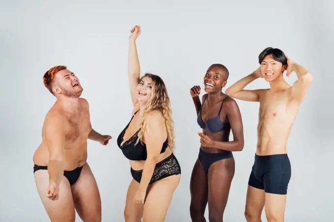 Group of young people dancing, wearing underwear