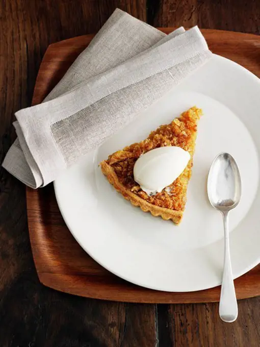 Plate of treacle tart with ice cream