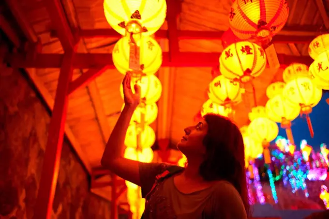 Tourist reading blessings on chinese lantern, Kek Lok Si Temple, Penang Island, Malaysia
