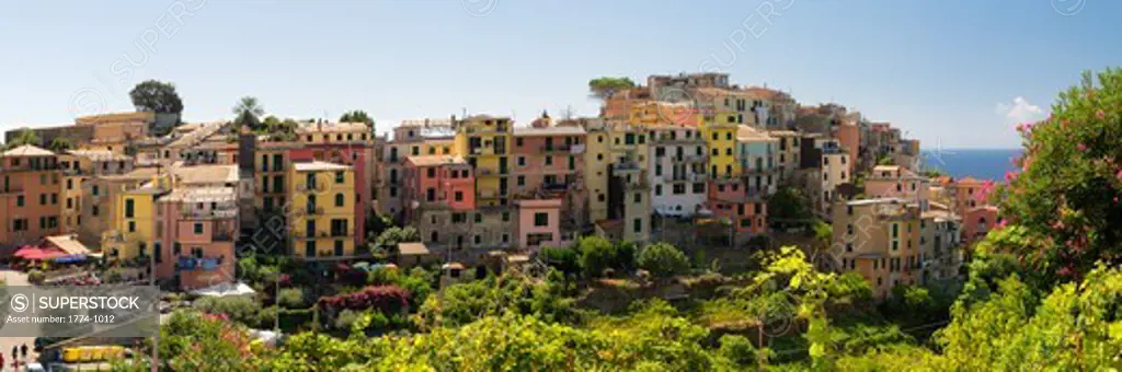 Italy, Liguria, Cinque Terre, Corniglia, High angle panoramic view of small coastal town