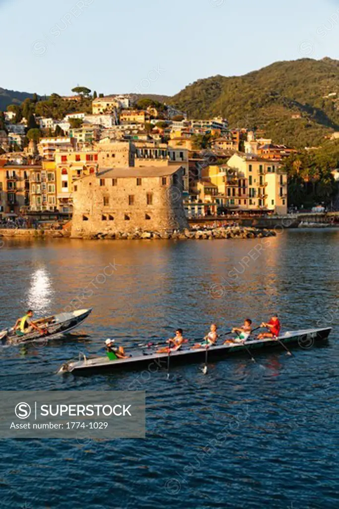 Italy, Liguria, Rapallo, Teenager boys of Rowing Club training in harbor