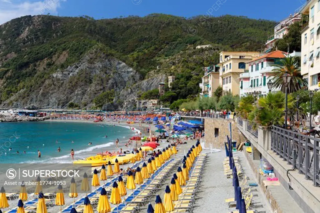 Italy, Liguria, Cinque Terre, Monterosso Al Mare, Row of lounge chairs and umbrellas on beach