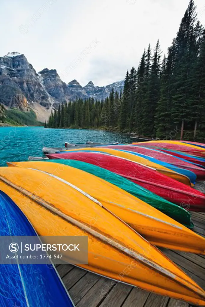 Canada, Banff National Park, Moraine Lake, colorful canoes stored on dock