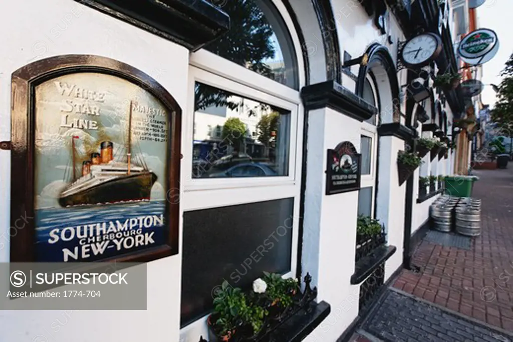 Ireland, County Cork, Cobh, Pub Exterior with Historic Luxury Steam Boat Advertisement Sign