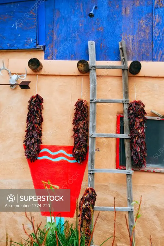 USA, New Mexico, Truchas, Wall of house with chile ristras