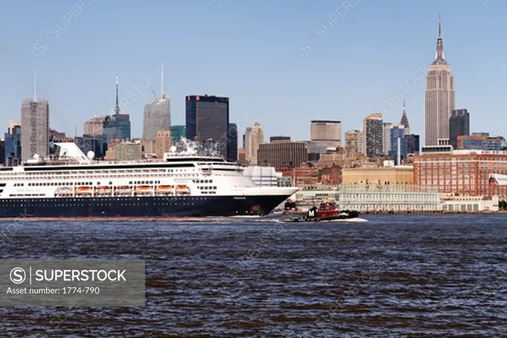 USA, New York State, New York City, Cruise Ship Sailing Down Hudson River with Manhattan Skyline in Background