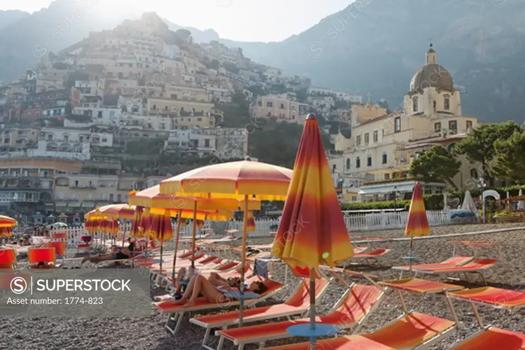 Italy, Campania, Positano, Lounge chairs and umbrellas on beach