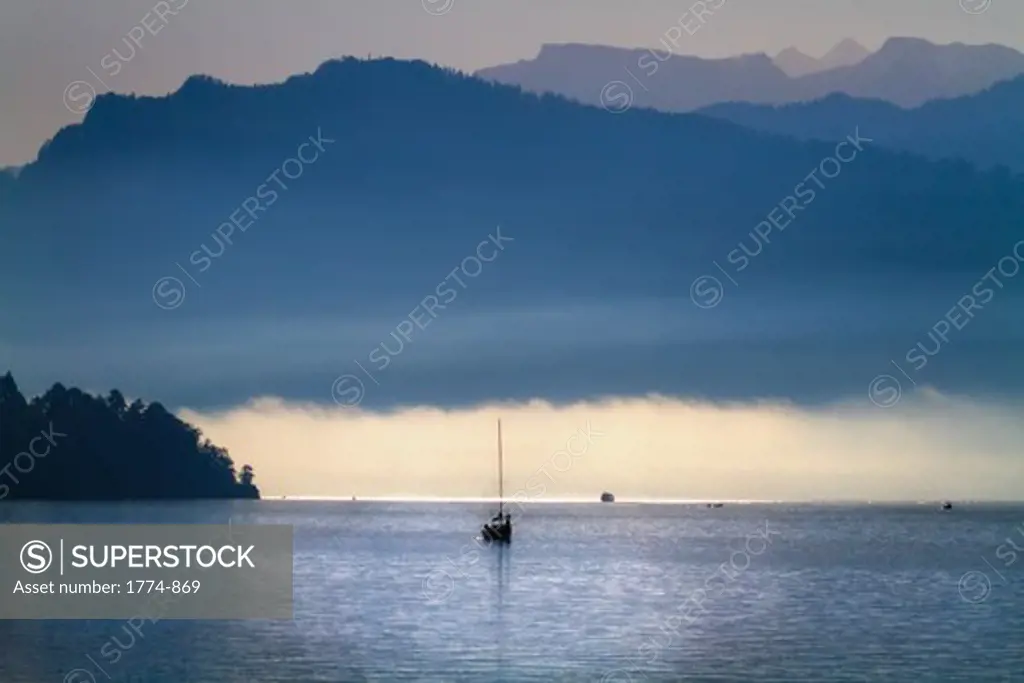 Boat in the lake at misty morning, Lake Lucerne, Switzerland