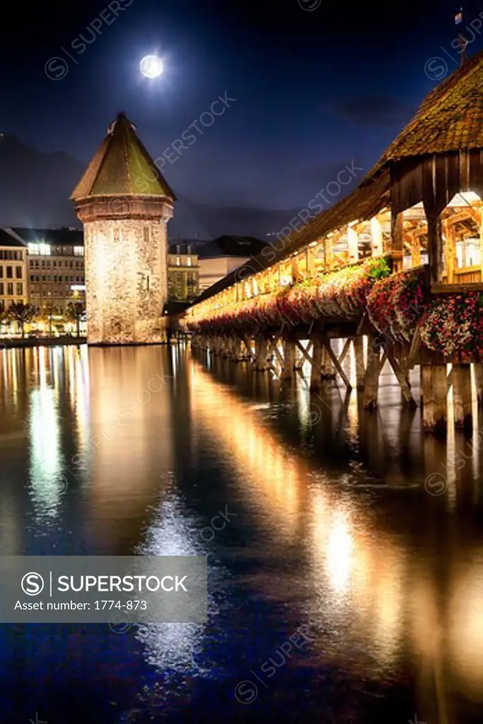 Chapel Bridge lit up at night over the Reuss River, Lucerne, Switzerland